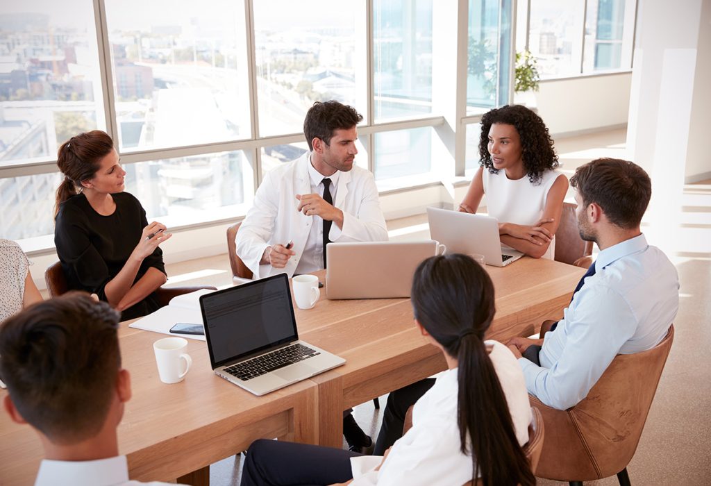 Doctors in boardroom having meeting about DRG validation