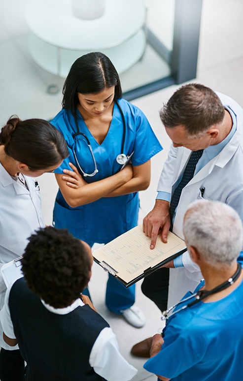 on-demand-img Doctors huddled up discussing schedule